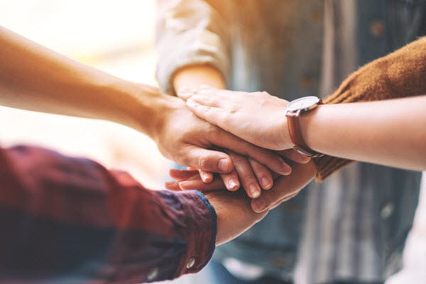 people of different ethnics  holding hands